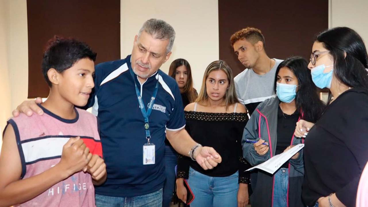 Eddy Conde, professor, with students and people from 