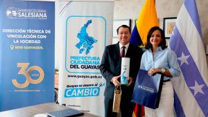 Fr. Juan Cárdenas and Marcela Aguiñaga signing the agreement